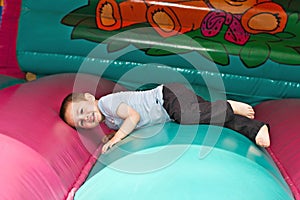 Boy playing on inflatable slide