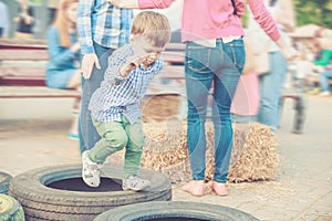 Boy Playing Jumping Tires on Street Festival