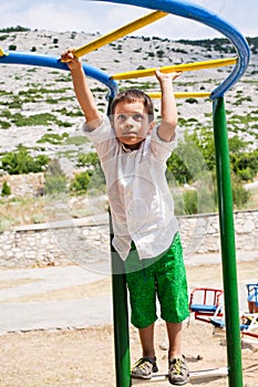 Boy playing on jungle gym