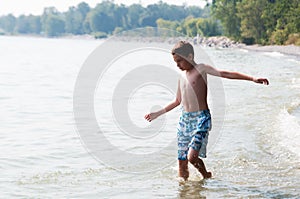 Boy playing in a lake