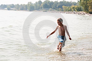 Boy playing in a lake