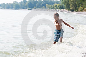 Boy playing in a lake