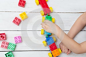 The boy is playing lego. Developing occupation for the child