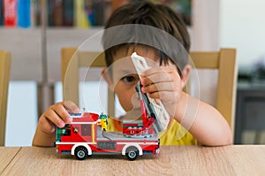 Boy playing with Lego fire truck