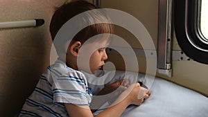 Boy playing mobile games in train