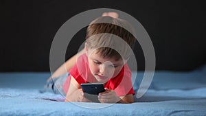 Boy playing on a mobile phone