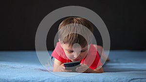 Boy playing on a mobile phone