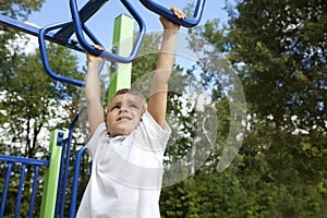 Boy playing on monkey bars