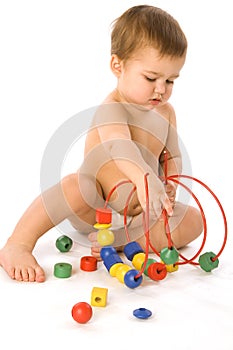 Boy playing with multicolored cubes and curl