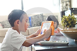 Boy playing online games on tablet