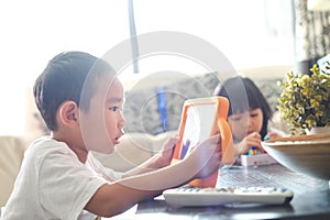 Boy playing online games on tablet