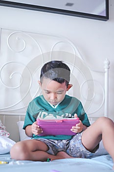 Boy playing online games using tablet