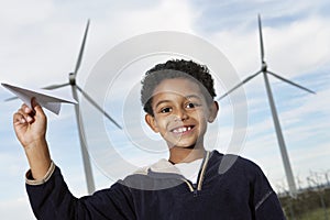 Boy Playing With Paper Plane At Wind Farm