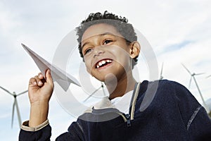 Boy Playing With Paper Plane At Wind Farm