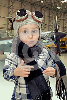 Boy playing with pilots hat