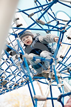 a boy playing on a playground in a maze