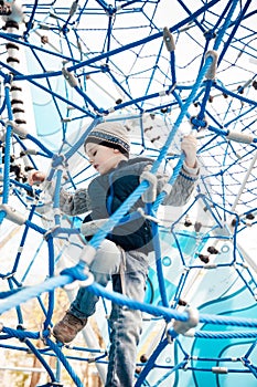 a boy playing on a playground in a maze