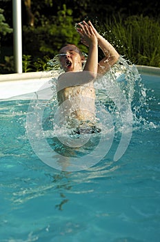 Boy playing in pool