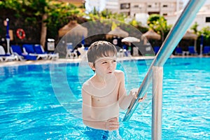Boy playing on pool.