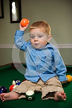 Boy playing on pool table
