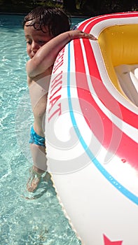 A boy playing pool water