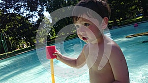 A boy playing pool water