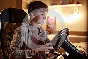 boy playing racing simulator