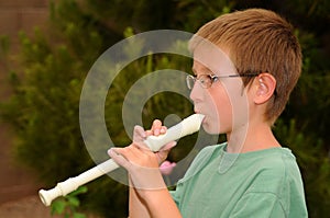 Boy playing a recorder photo