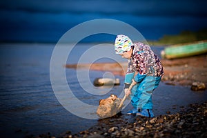 boy playing by the river, selective focus