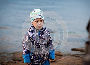boy playing by the river, selective focus
