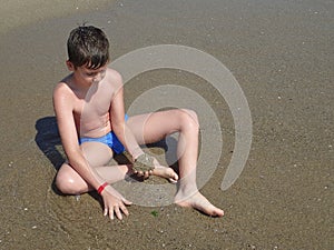 Boy playing in the sand