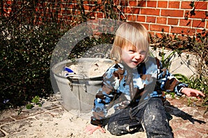 Boy playing beside sand box