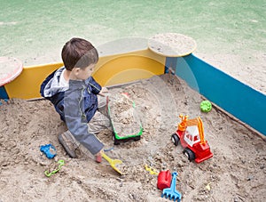 Boy playing in sandbox