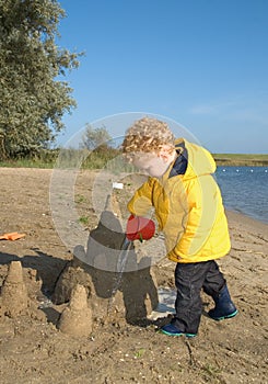 Boy playing with Sandcastle