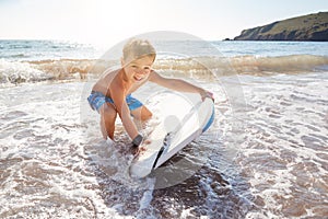 Boy Playing In Sea With Bodyboard On Summer Beach Vacation