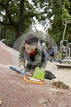Boy playing with shovel and bucket