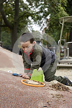Boy playing with shovel and bucket