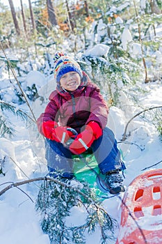 Boy playing in big snow in winter.