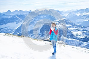 Boy playing snow ball fight in snow mountains