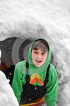 Boy Playing in Snow Fort, Winter