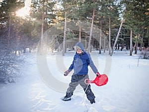 Boy playing with snow. High quality photo.