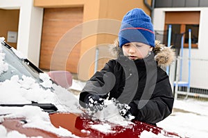 Boy playing with snow outside