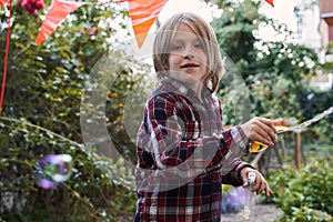 Boy playing with soap bubbles