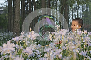 Boy playing soapbubbles