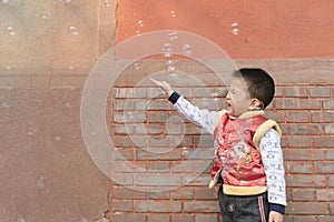 Boy playing soapbubbles
