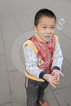Boy playing soapbubbles