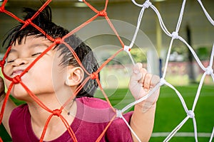 Boy playing with Soccer Football Goal net for sport