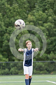 Boy playing soccer - taking a throw in