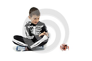 Boy playing with spider robot toy, isolated on white