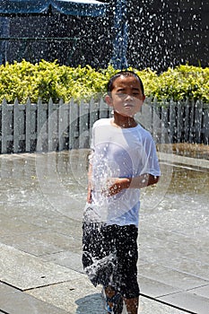 Boy playing in Sun shower